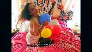 Sexy Brunette Blowing Balloons in Bed Wearing Thigh High Stockings