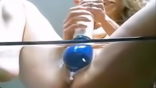 A pretty and nasty blonde girl gives herself a milk pussy enema using a weird toy
