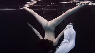 Andrejka slowly takes down her skirt while diving in the pool