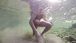 Boy swiming naked in the water